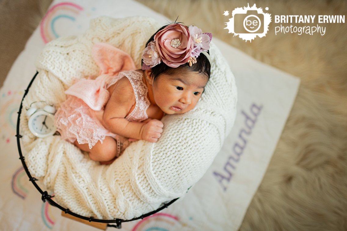 newborn-baby-girl-with-custom-monogram-blanket-rainbow-with-alarm-clock.jpg