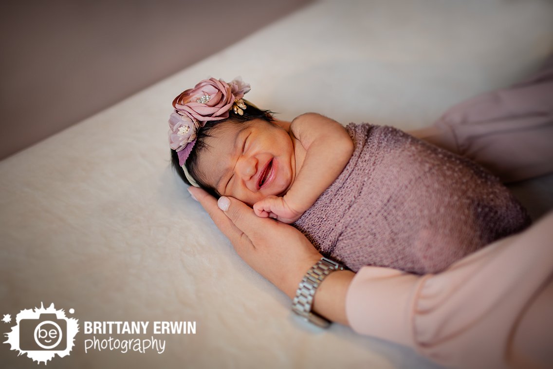 Indianapolis-newborn-portrait-photographer-baby-girl-wrapped-in-crib-with-mothers-arms.jpg