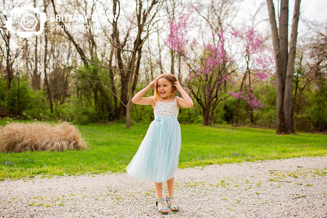 spring-blooms-redbud-tree-on-gravel-path-girl-in-easter-dress-and-sandals-playing.jpg