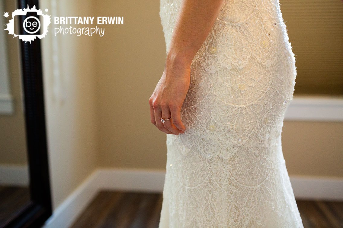 bride-wearing-engagement-ring-lace-gown-dress.jpg