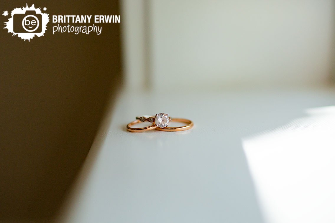 wedding-rings-with-engagement-ring-detail-on-window-sill.jpg