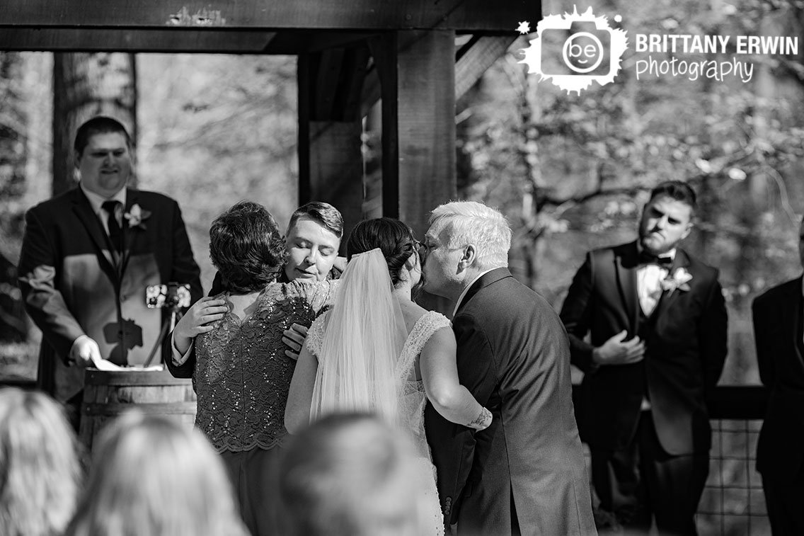 wedding-photographer-bride-walking-down-aisle-with-parents.jpg