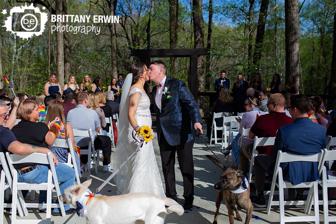 couple-kiss-after-wedding-ceremony-walking-dogs.jpg