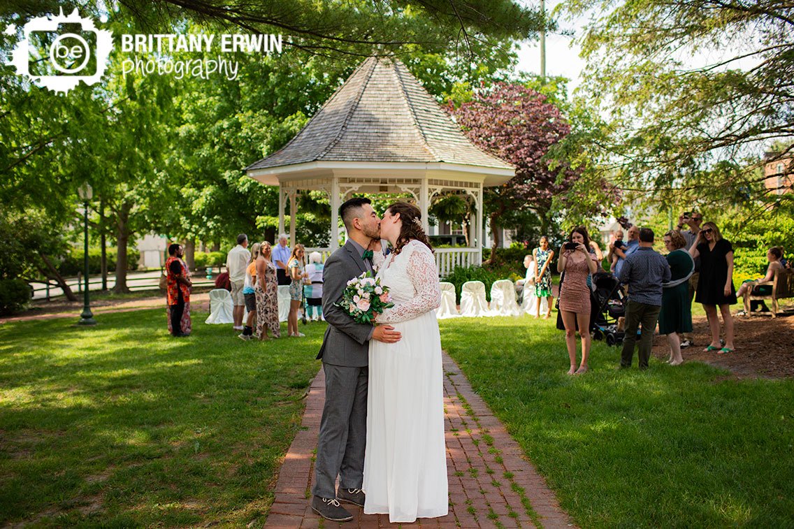 Zionsville-Indiana-elopement-photographer-couple-after-ceremony-kiss-on-aisle-brick-path.jpg