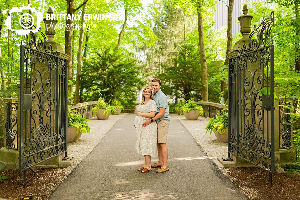 Indianapolis-maternity-portrait-photographer-outside-couple-iron-gate-ornate-park-Newfields.jpg