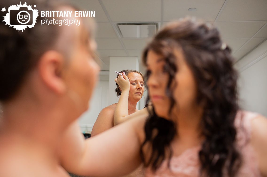 Indianapolis-wedding-photographer-bride-getting-ready-bridesmaid-helping-with-makeup.jpg