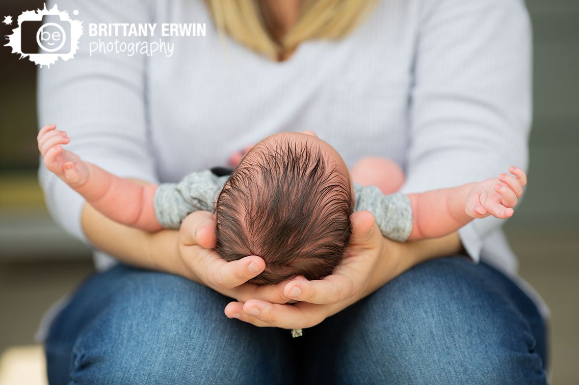 mother-holding-baby-boy-outside-newborn-photographer.jpg