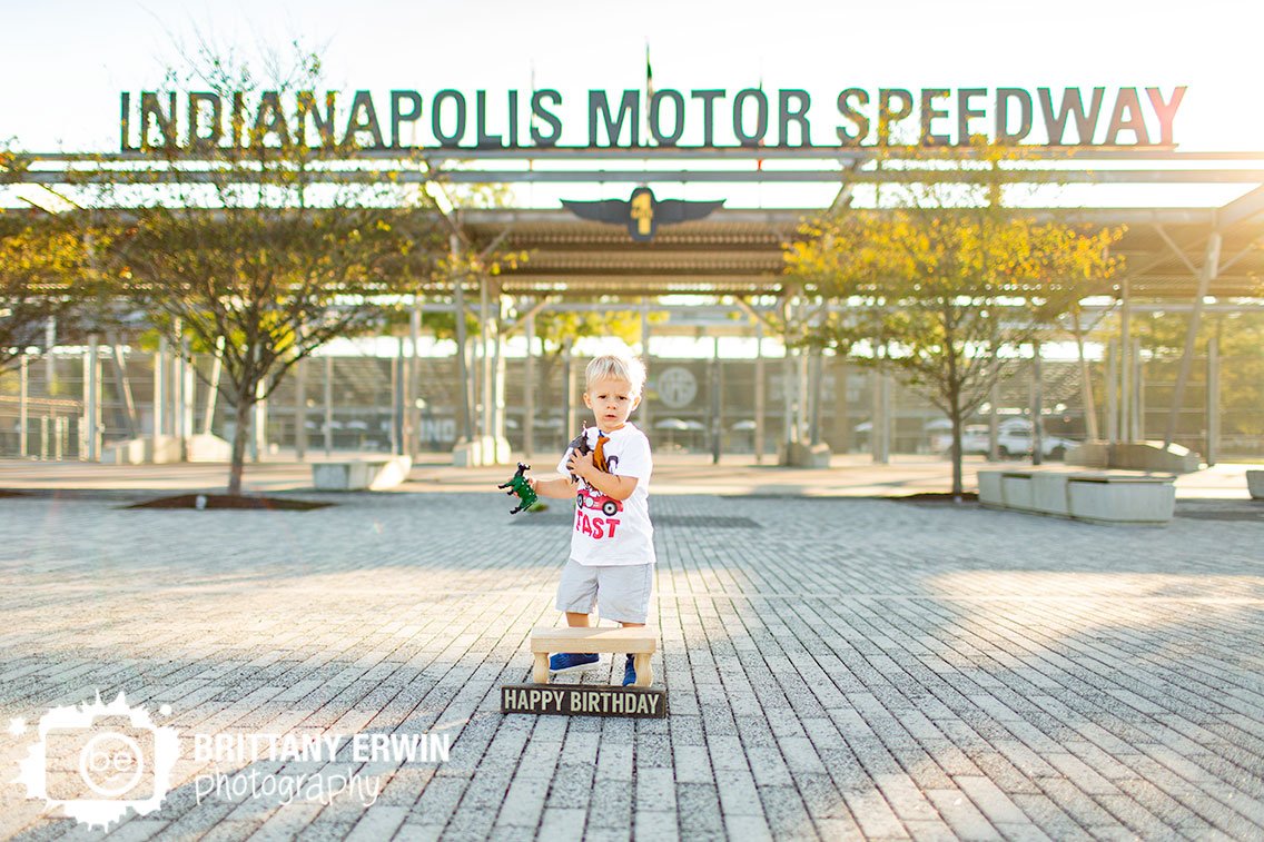 Indianapolis-Motor-Speedway-main-gate-birthday-portrait-boy-with-toys-happy-birthday-sign.jpg