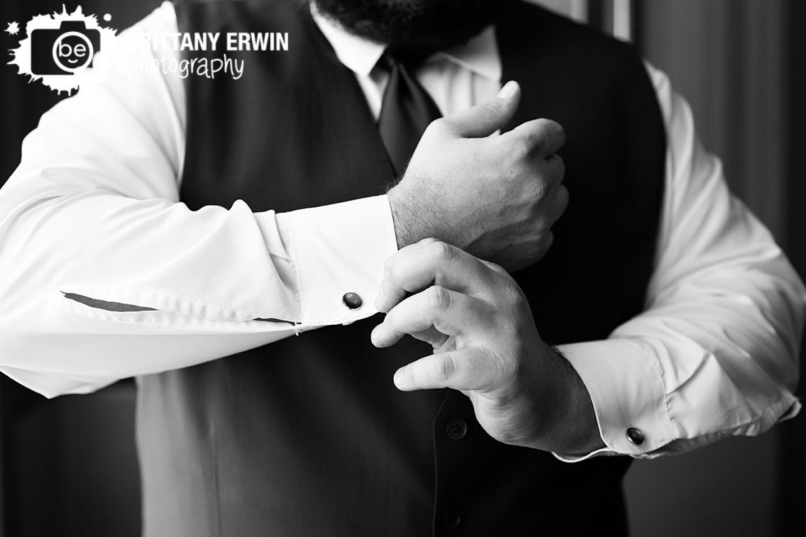 groom-getting-ready-by-window-cufflinks.jpg