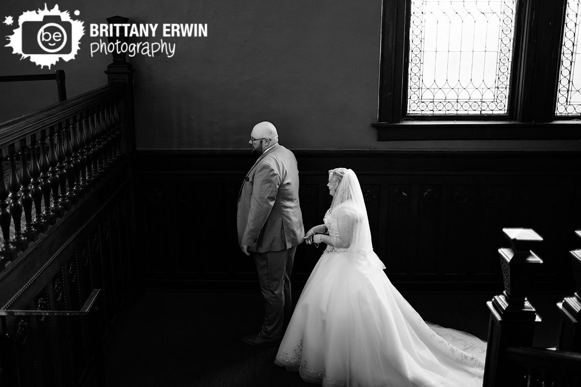 couple-on-staircase-at-Rathskeller-first-look-bride-walking-up-to-groom.jpg