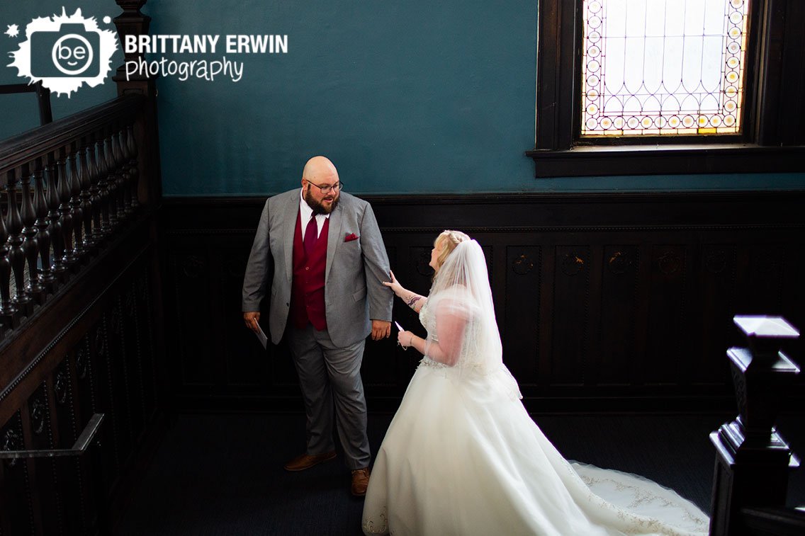 groom-reaction-first-look-on-stained-glass-staircase-Rathskeller.jpg