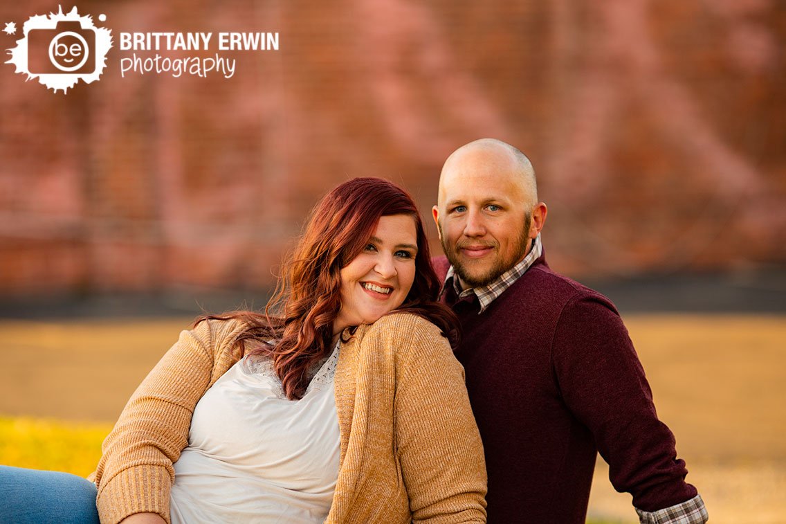 Fountain-square-Indiana-engagement-portrait-photographer-couple-on-hill-with-brick-wall.jpg