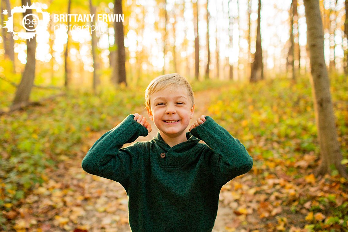 silly-boy-green-sweater-outdoor-portrait-photographer.jpg