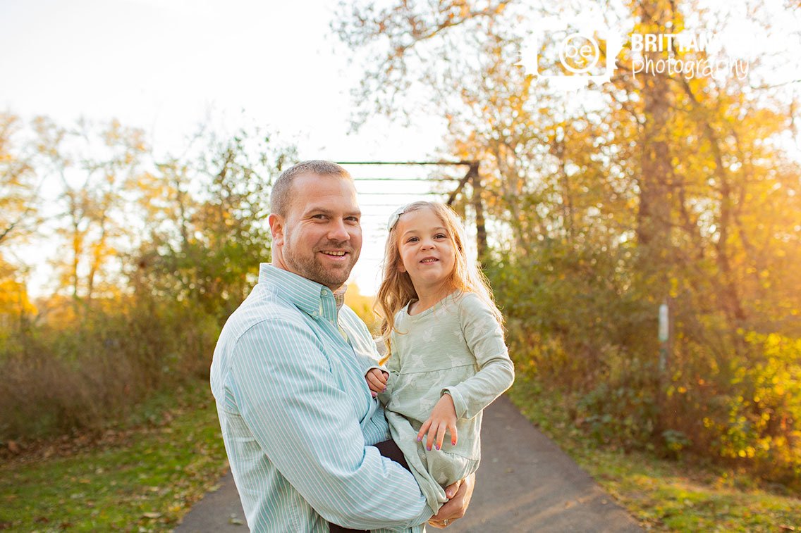 father-daughter-portrait-outdoor-fall-on-path.jpg