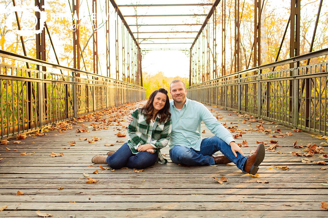 couple-on-bridge-wooden-and-steel-built-fall.jpg