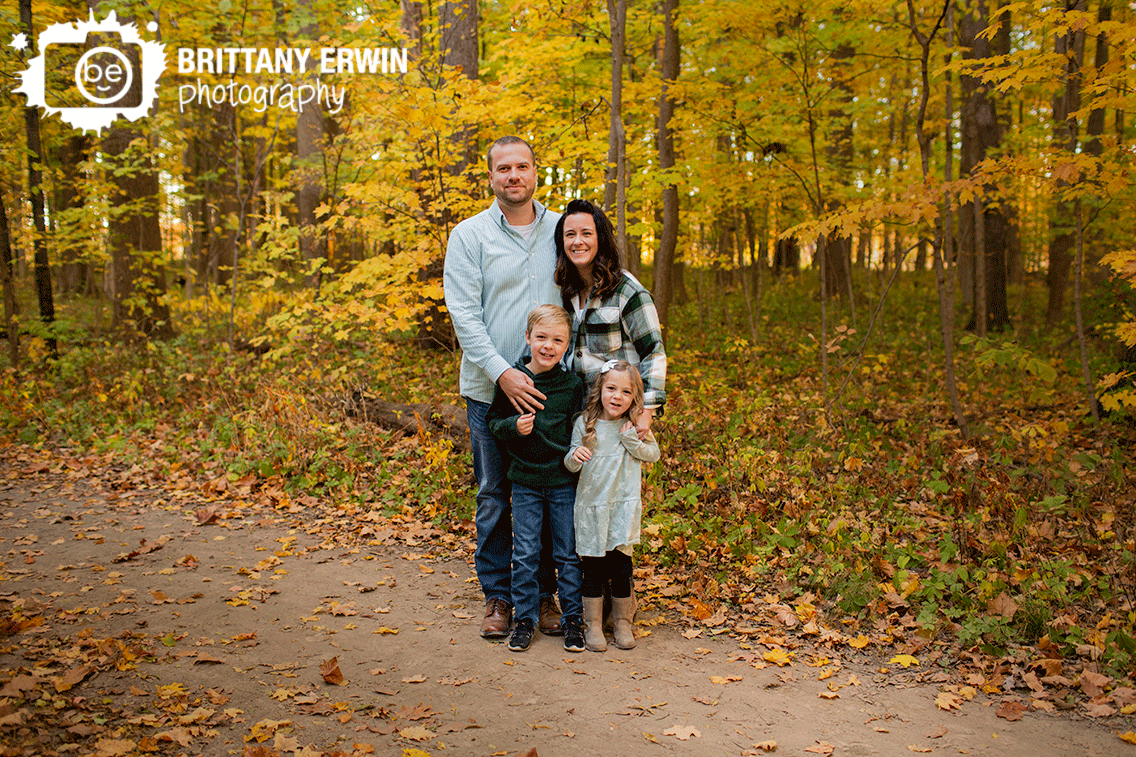Family-portrait-photographer-fall-group-on-path-with-yellow-trees.gif
