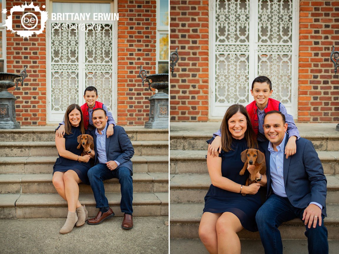 Coxhall-Gardens-family-portrait-photographer-group-sitting-on-steps-with-iron-door.jpg