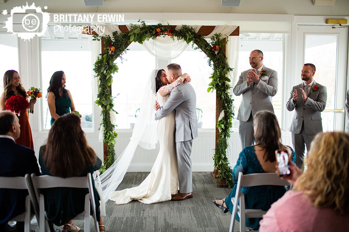 first-kiss-at-wedding-ceremony-indoor-Ricks-Cafe-Boatyard.jpg