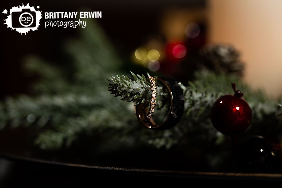 Ring-detail-photo-engagement-wedding-bands-on-fir-tree-branch-with-berries.jpg