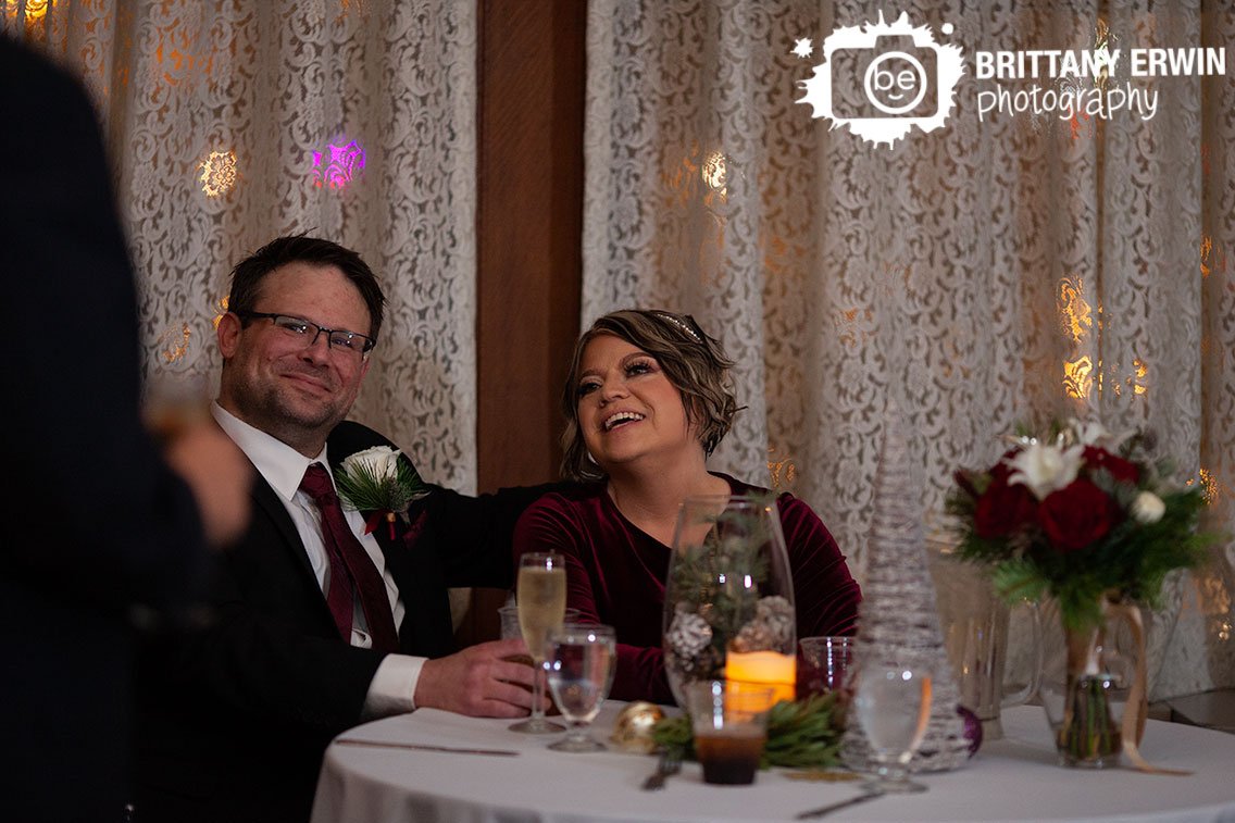 Indianapolis-indoor-wedding-reception-lace-curtains-couple-at-sweetheart-table-during-toasts.jpg