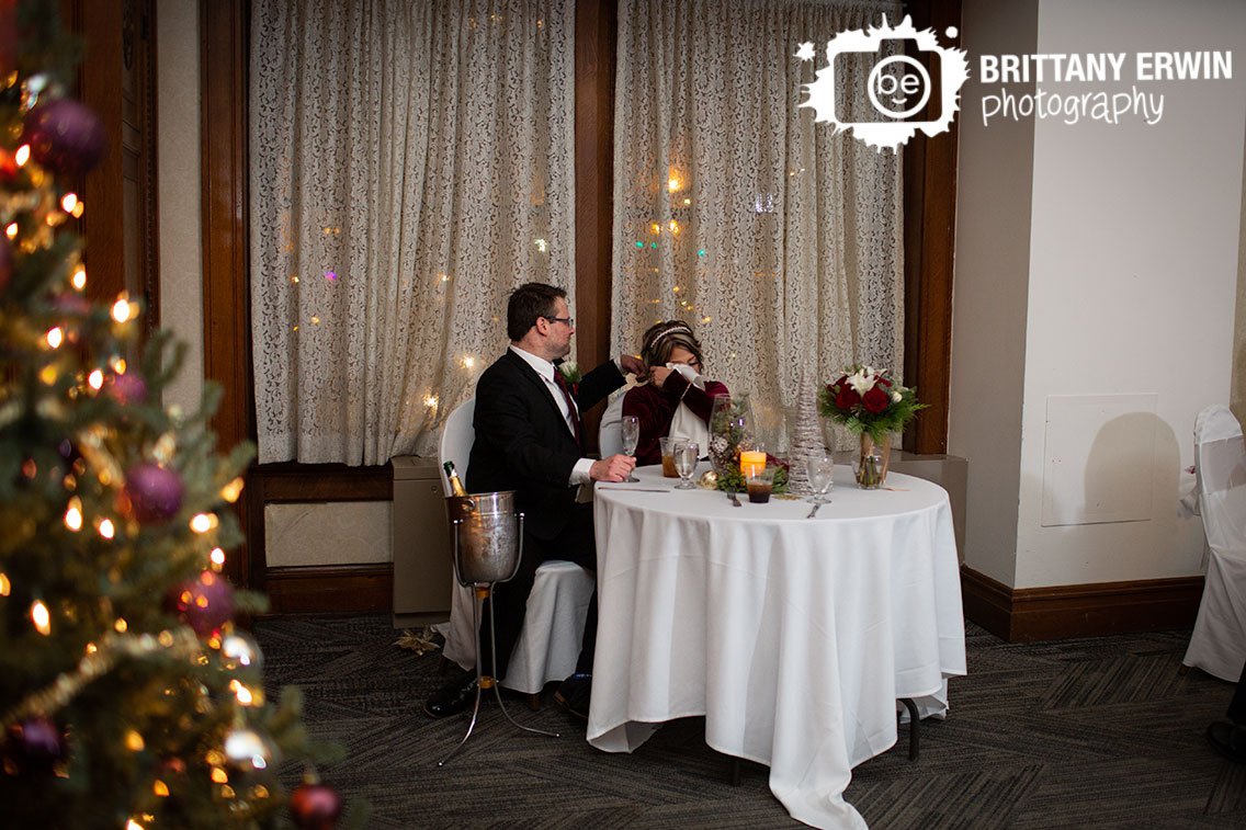 bride-reaction-wedding-photographer-drying-eyes-groom-at-head-table.jpg