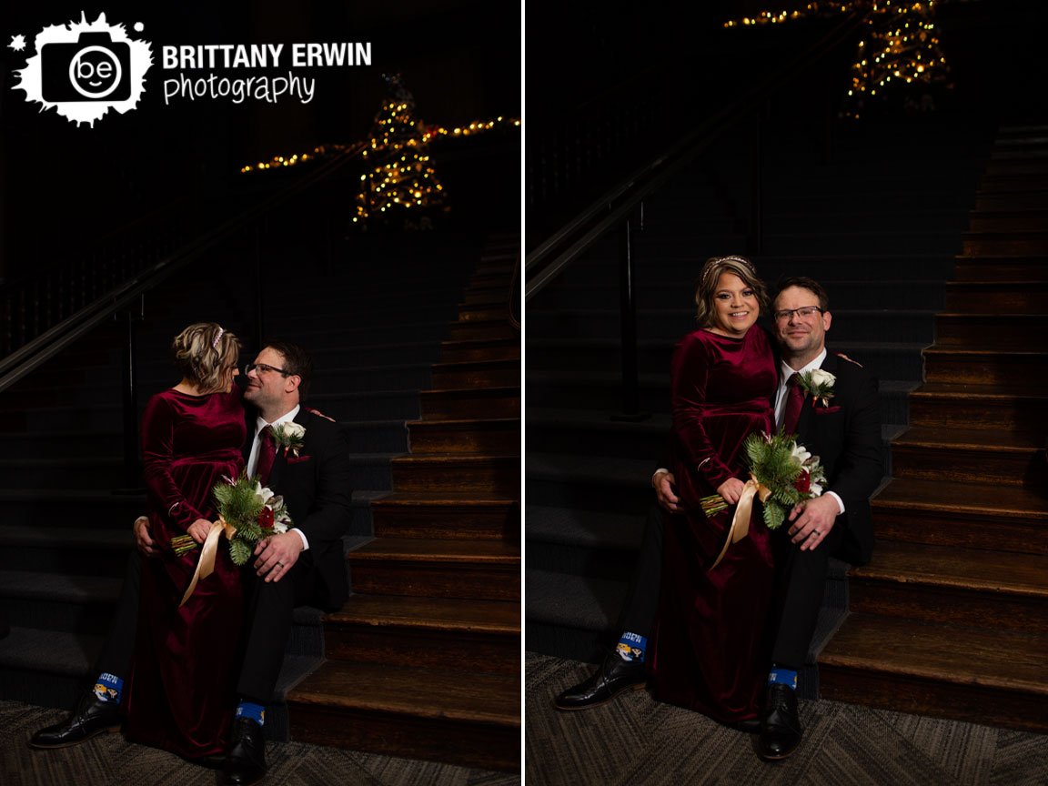 Rathskeller-Indianapolis-wedding-photographer-couple-christmas-tree-stairs-at-coat-check-with-decorations-at-top.jpg