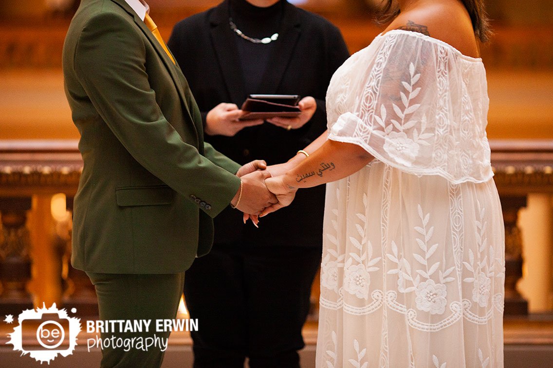 Indianapolis-wedding-photographer-couple-holding-hands-at-ceremony.jpg