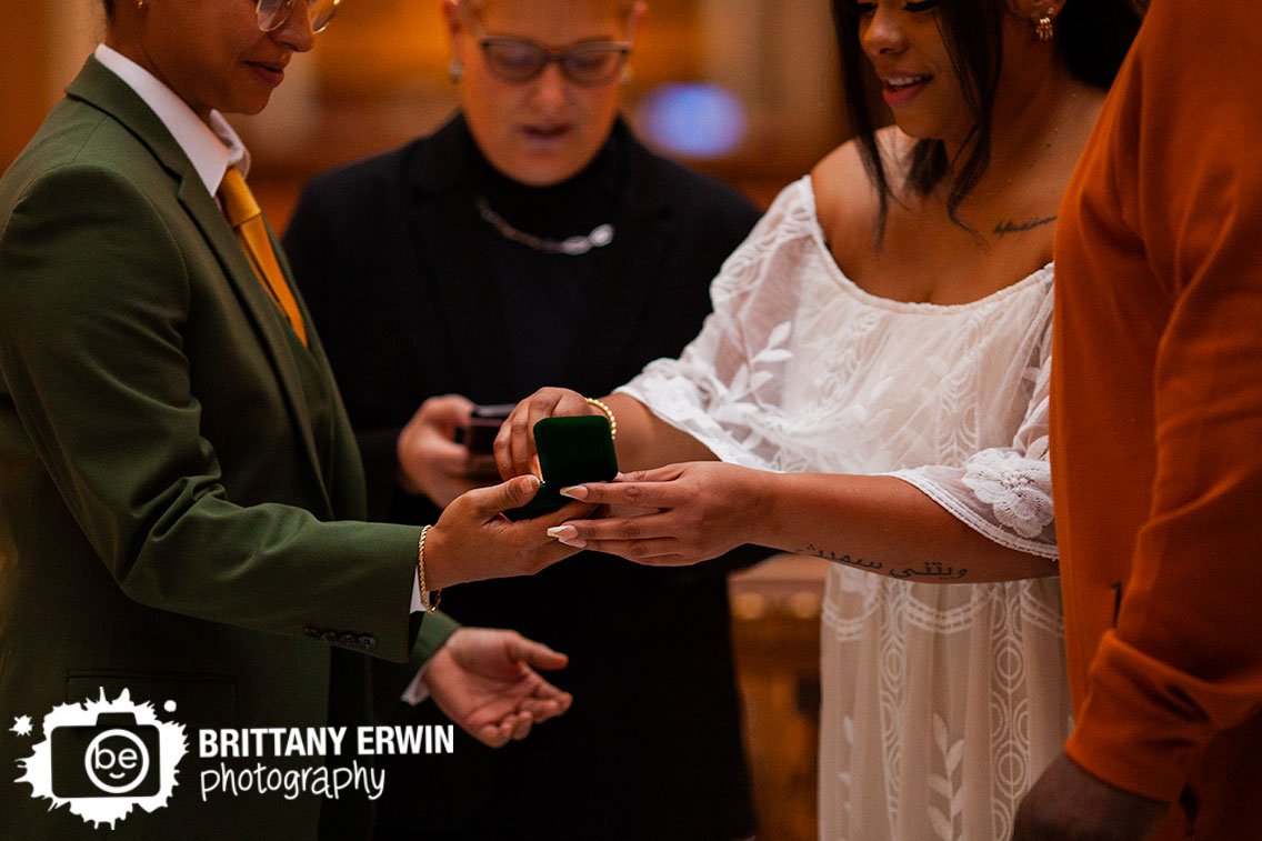 bride-taking-ring-from-lighted-box-indoor-wedding-ceremony.jpg