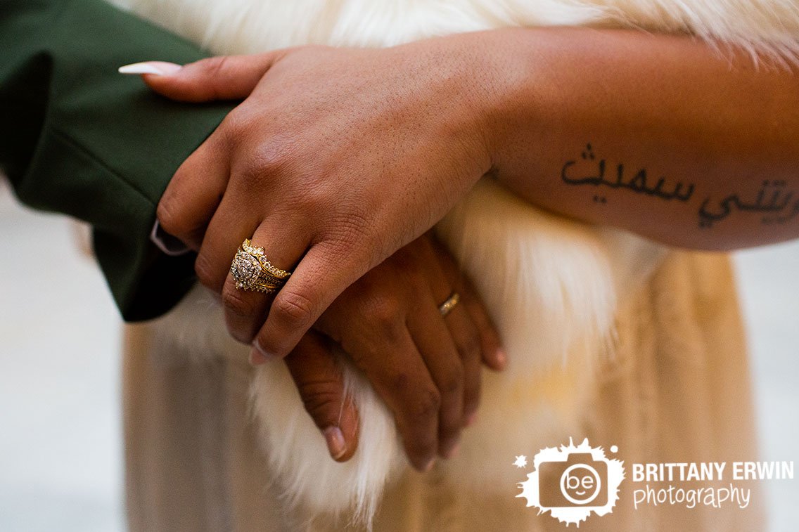 detail-photo-rings-couple-holding-hands-over-fur-shawl.jpg