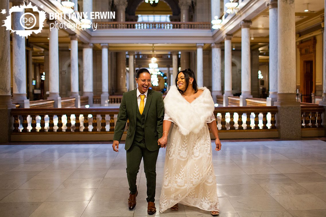 Indianapolis-winter-wedding-photographer-couple-laughing-walking-inside-state-house.jpg