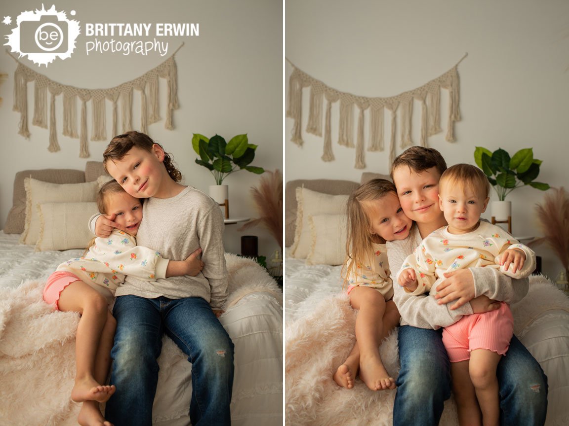 siblings-portrait-natural-light-studio-with-boho-wall-hanging.jpg