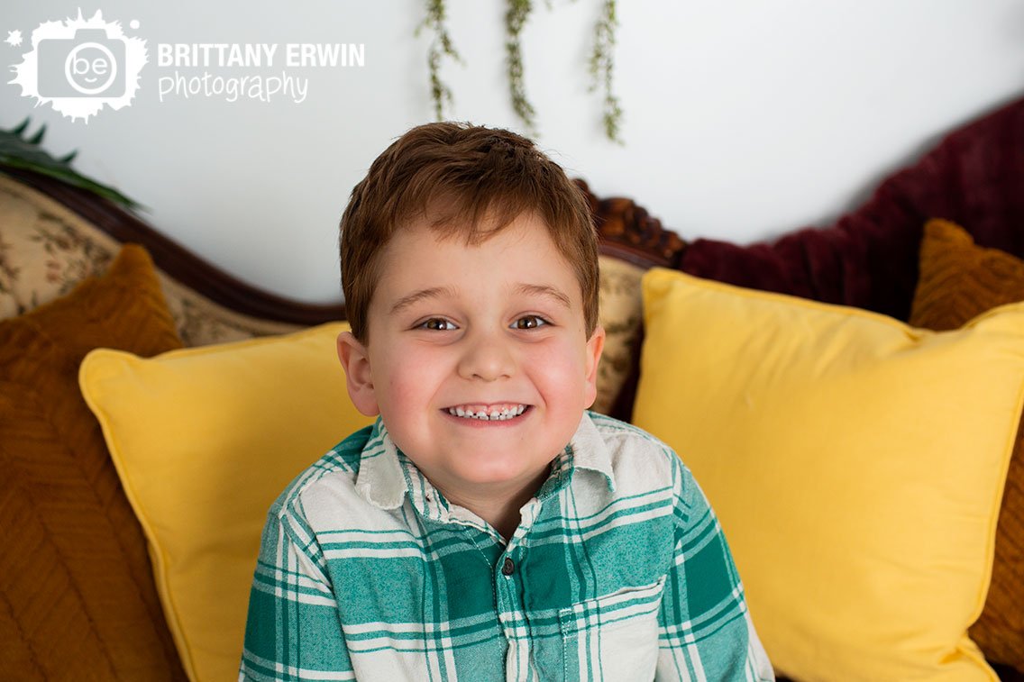 Indianapolis-portrait-photographer-boy-on-pillow-filled-antique-couch.jpg