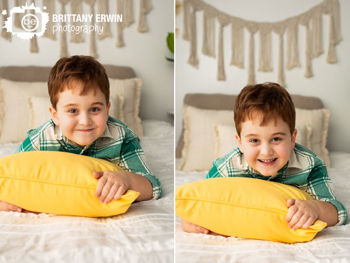 Indianapolis-portrait-photographer-boy-on-bed-with-bright-pillow-spring-colors.jpg