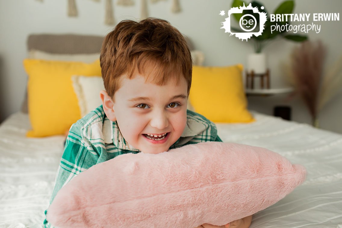 Indianapolis-portrait-photographer-boy-on-bed-with-fuzzy-pillow.jpg
