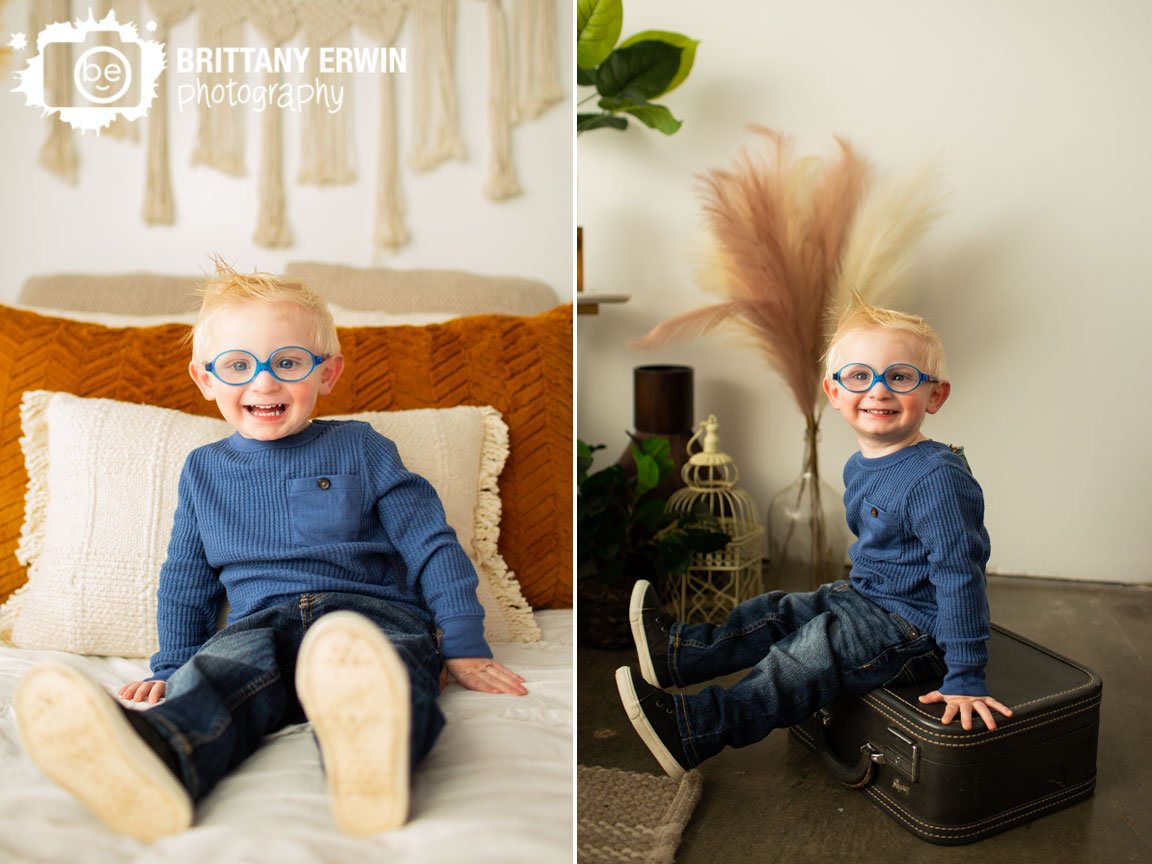 Indianapolis-portrait-photographer-boy-witth-glasses-on-antique-suitcase-happy-toddler.jpg