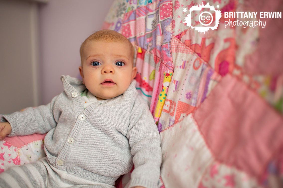 Indianapolis-portrait-photographer-baby-girl-on-pink-quilt-in-nursery.jpg