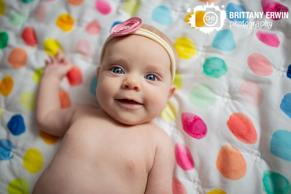 Indianapolis-indoor-lifestyle-portrait-photographer-milestone-session-on-colorful-quilt.jpg