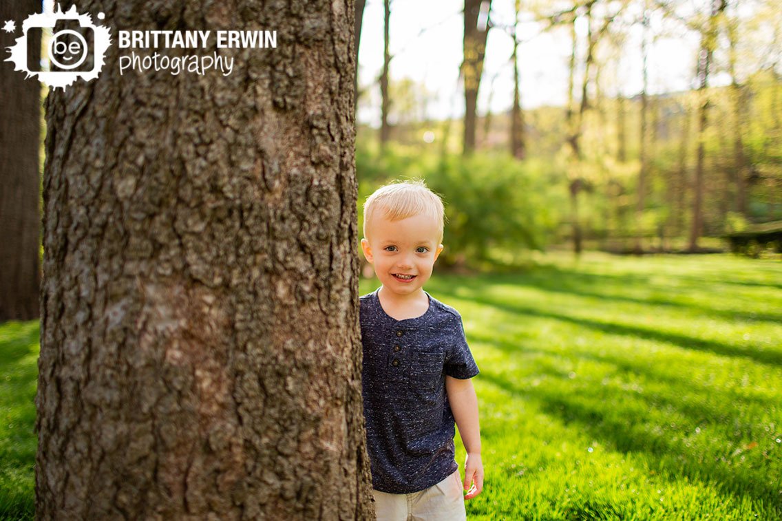 Spring-portrait-birthday-boy-behind-tree-playing.jpg
