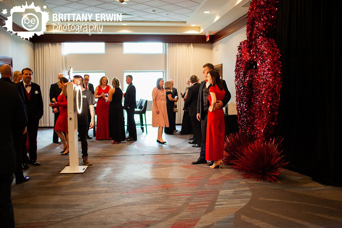 Indianapolis-event-photographer-guests-with-photobooth-red-background-setup.jpg