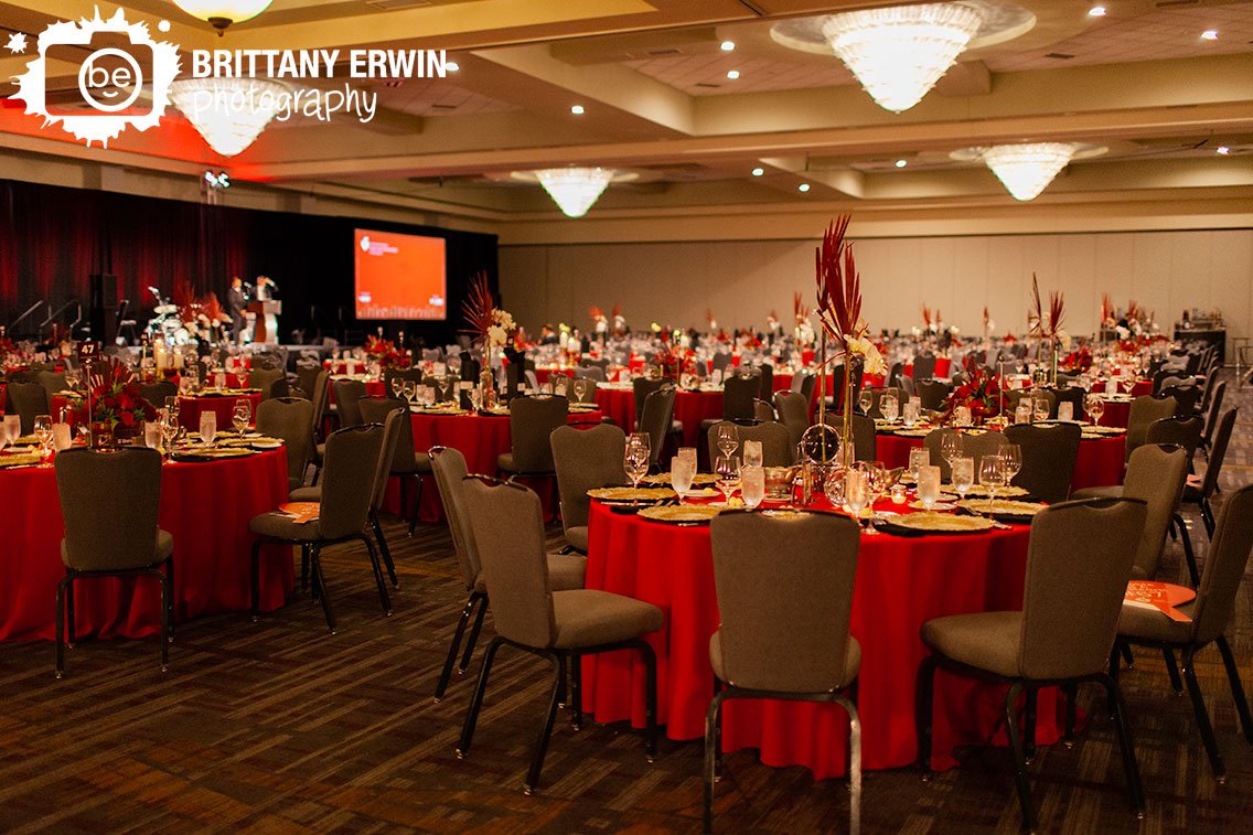 Indianapolis-event-photographer-tables-with-red-centerpieces-including-flowers-water-glass-vases.jpg