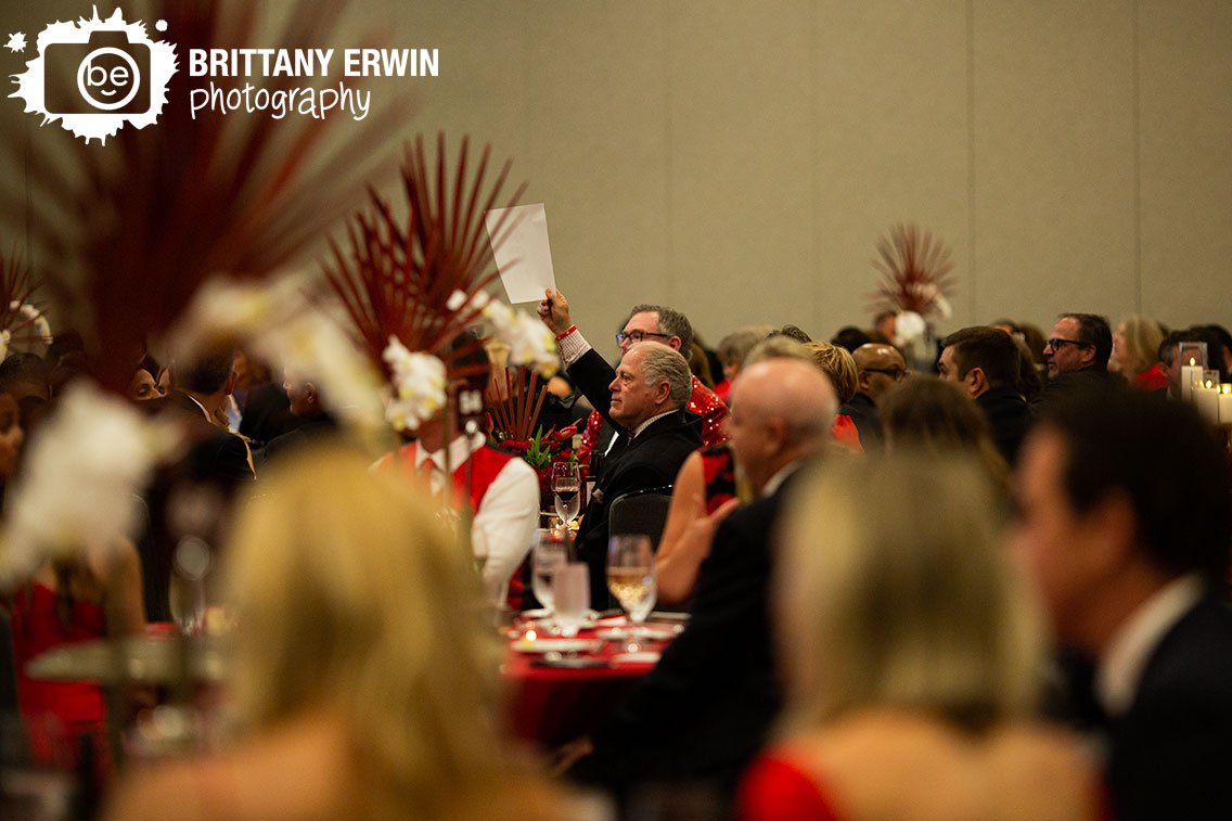 Indianapolis-american-heart-association-event-photographer-guest-bidding-during-live-auction.jpg