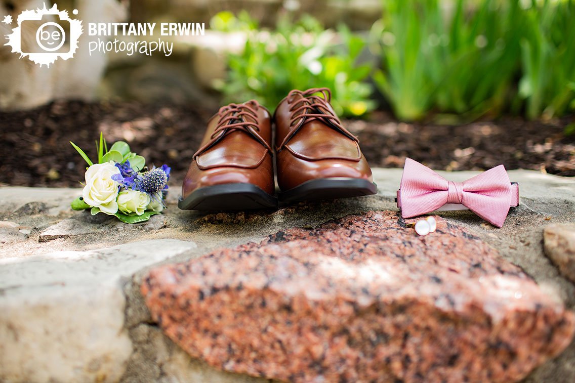 groom-details-on-stone-ledge-brown-leather-shoes-with-boutonniere-pink-bowtie.jpg