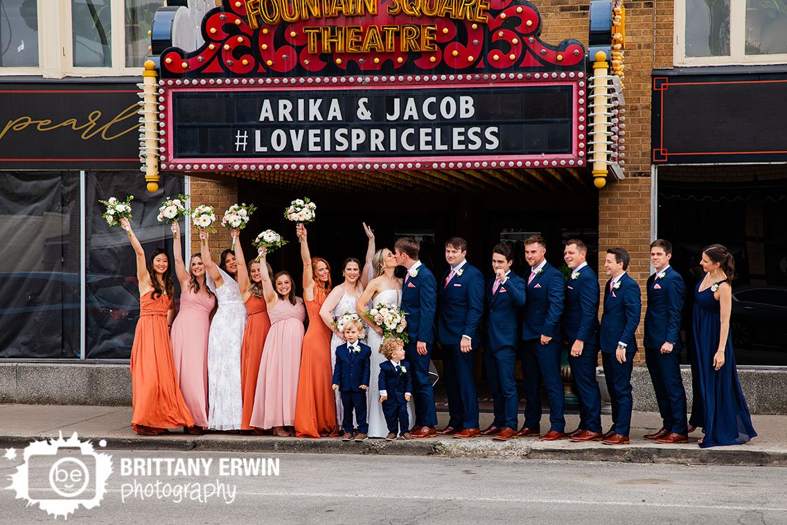 Bridal-party-cheering-coupe-kiss-under-marquee-Fountain-Square-Theatre.jpg