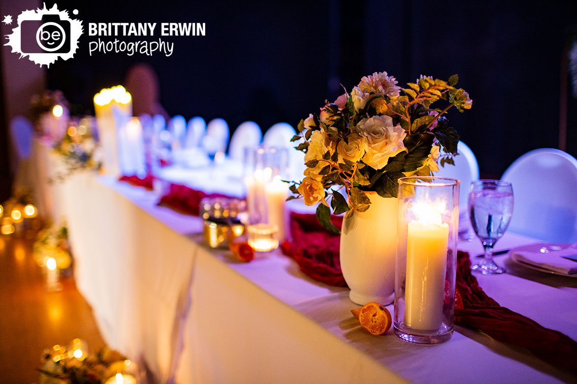 head-table-with-oranges-candles-and-flowers-in-vases.jpg