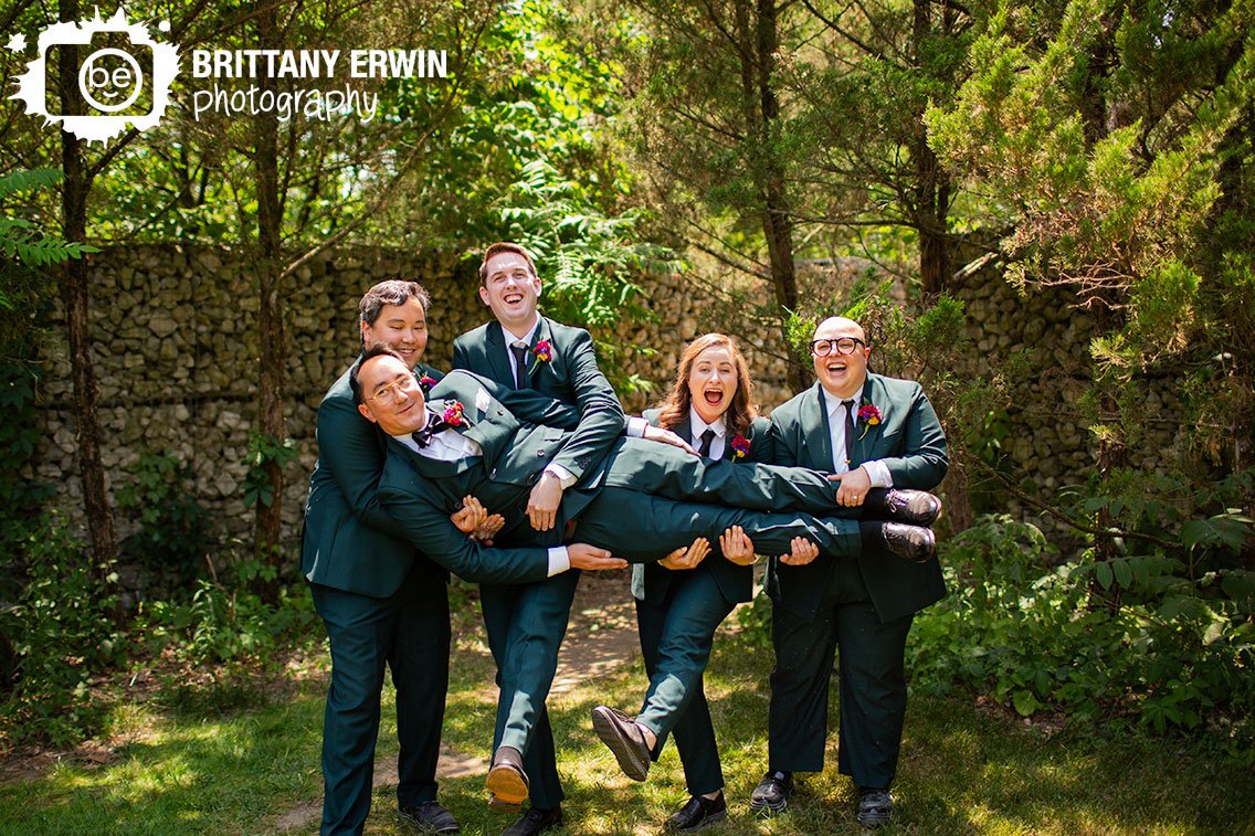 Groom-with-attendants-outside-group-holding-him-up.jpg