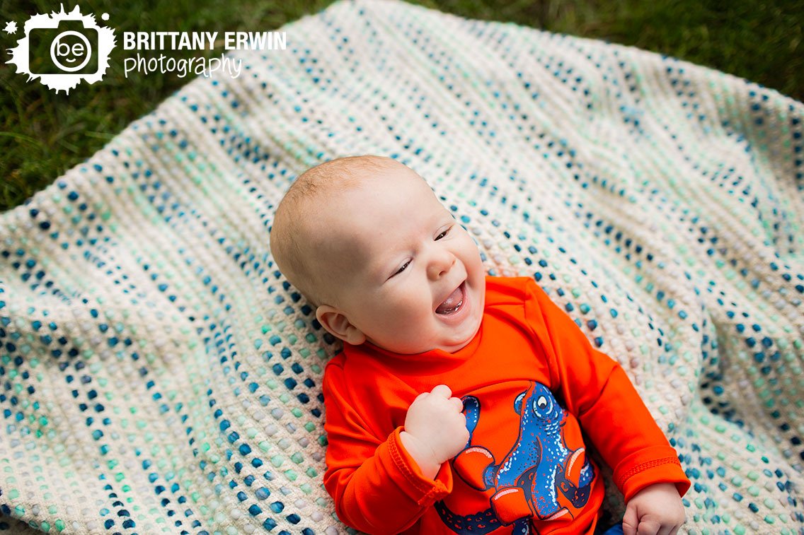 laughing-baby-boy-on-blue-blanket-outside.jpg