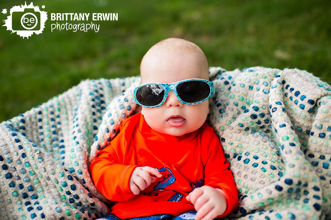 baby-boy-with-sunglasses-in-blue-textured-blanket-outside-summer.jpg