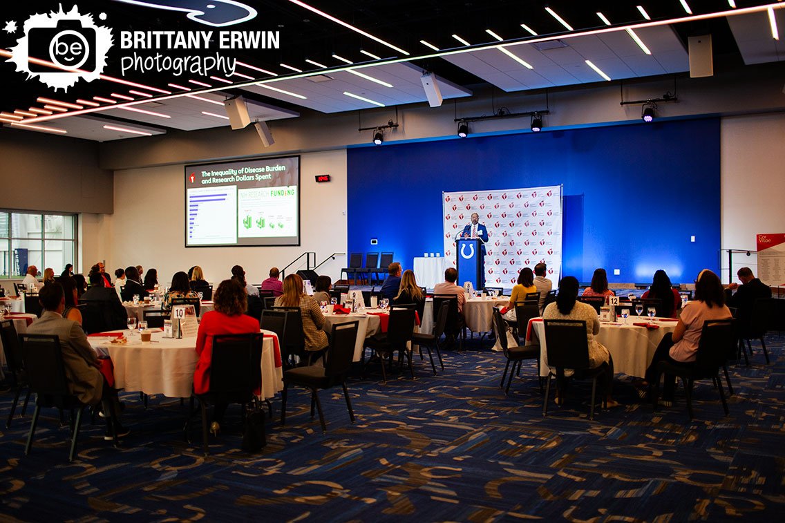 Indianapolis-event-photographer-American-Heart-Association-speaker-on-stage-Colts-Gridiron-hall.jpg