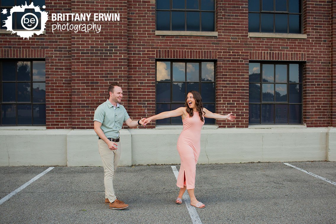 Couple-dancing-by-brick-wall-Indianapolis-engagement-photographer.jpg