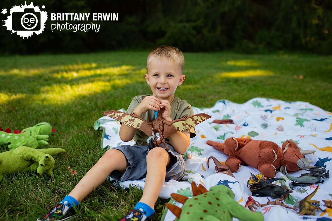 Summer-Indiana-portrait-photographer-boy-playing-with-dinosaur-outside-on-blanket.jpg
